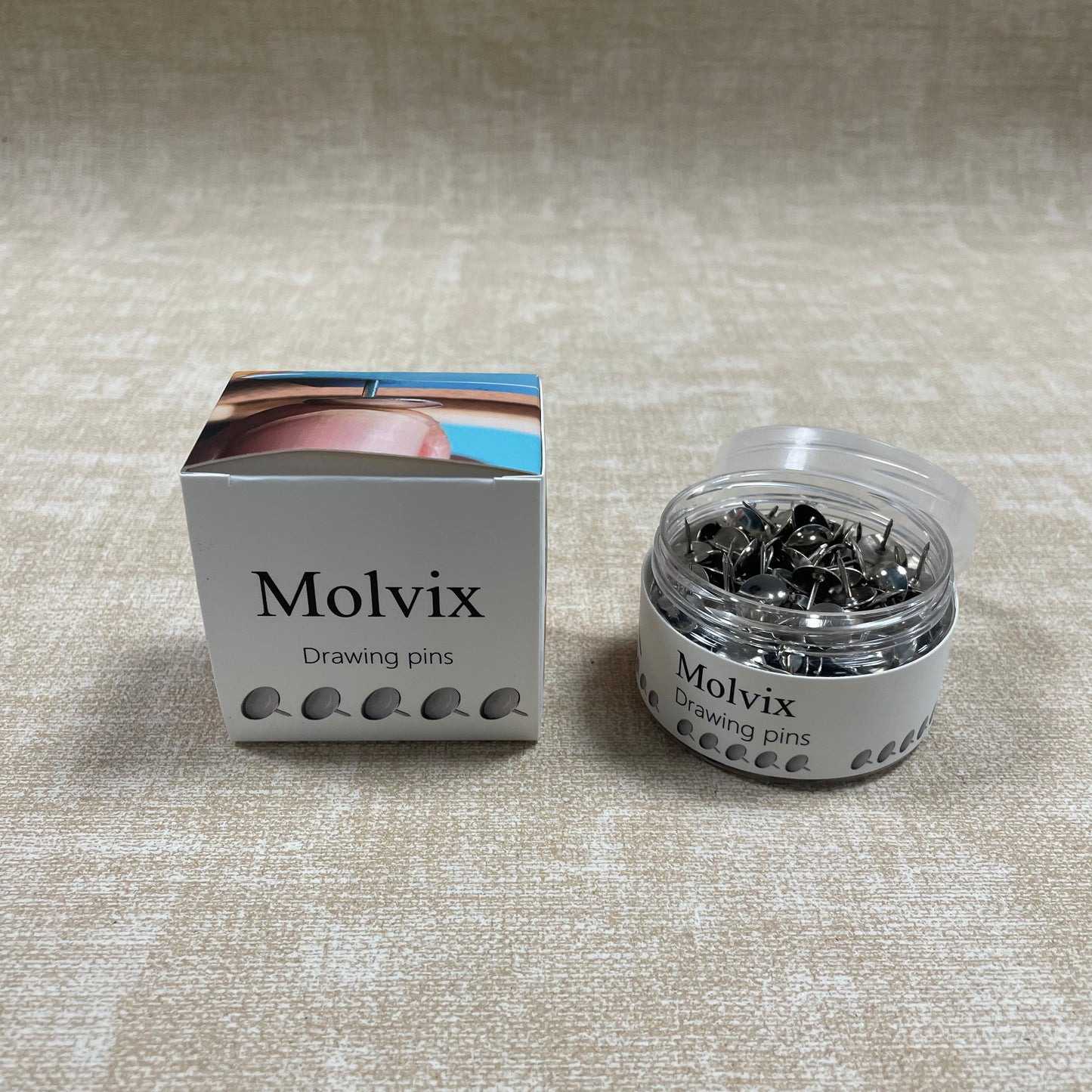 Molvix drawing pins are top-notch, durable metal pins housed in a handy round container, perfect for effortlessly securing your notes, photos, or papers in place.