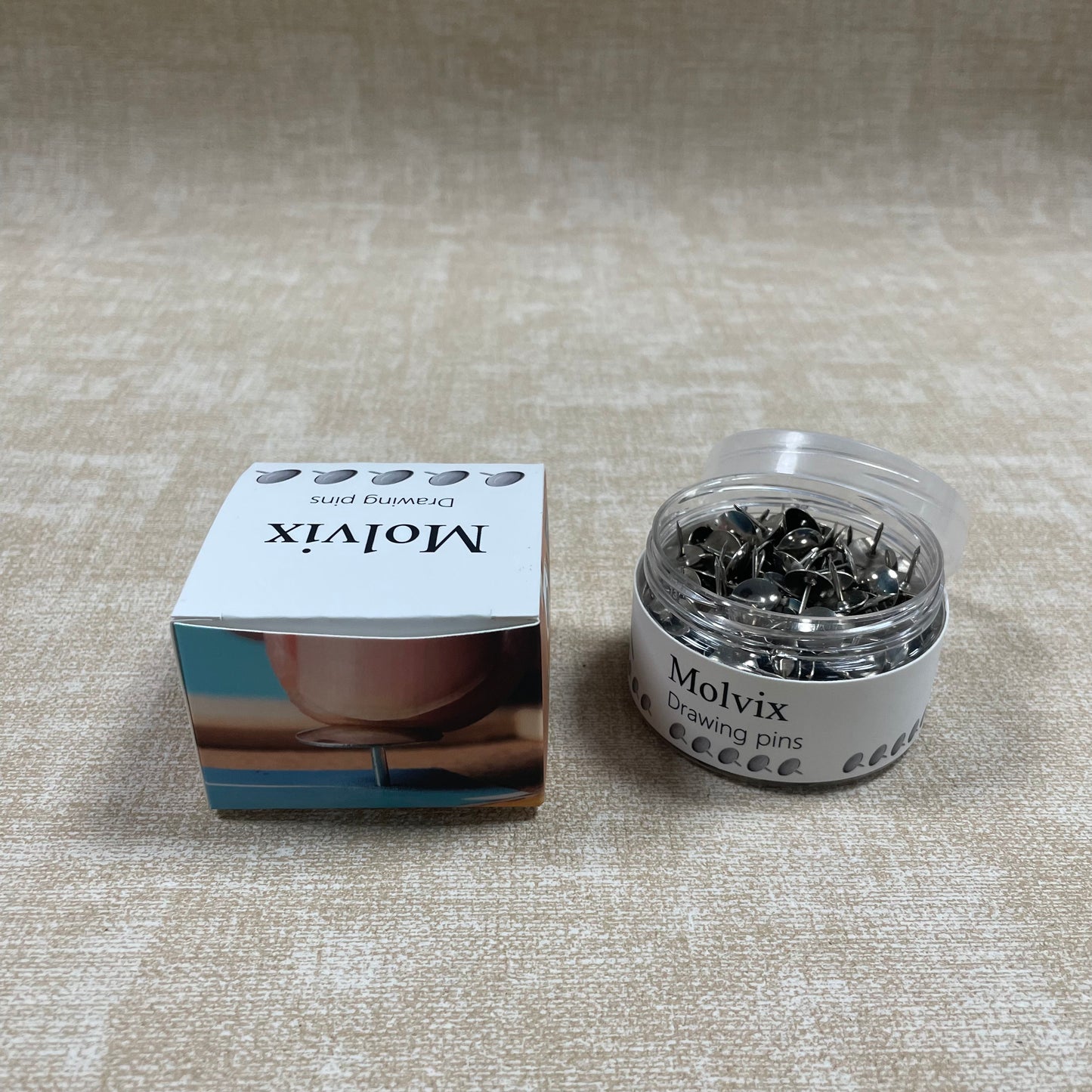 Molvix drawing pins are top-notch, durable metal pins housed in a handy round container, perfect for effortlessly securing your notes, photos, or papers in place.